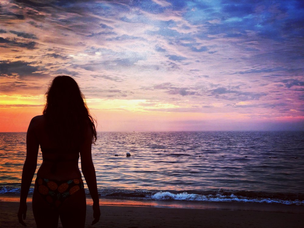 Silhouette watching the ocean at sunset